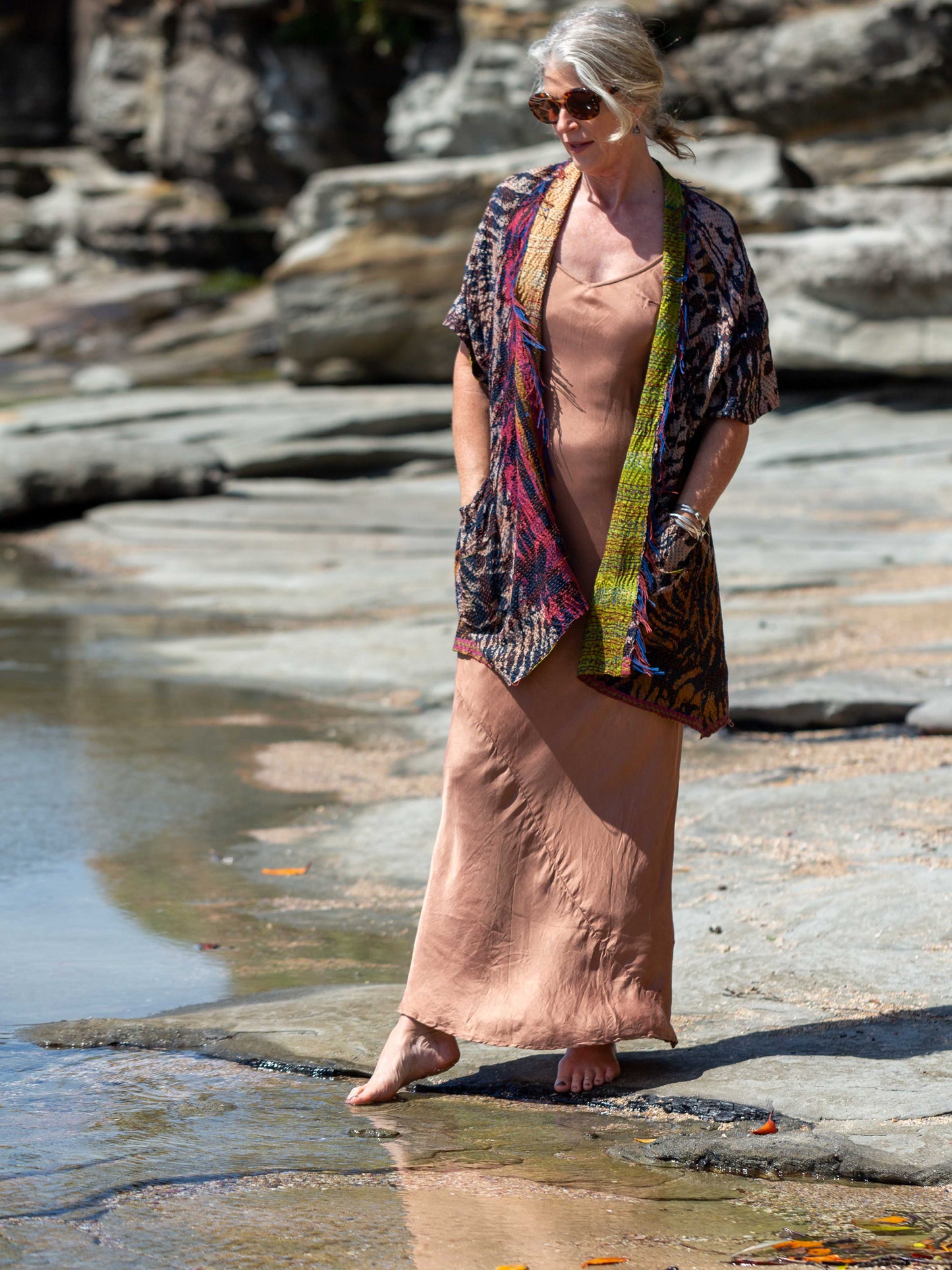 Woman wearing a silk slip with a silk reversible kimono in kantha stich. 