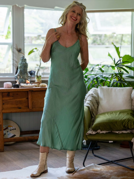 A bohemian look with woman wearing a soft moss coloured silk slip 