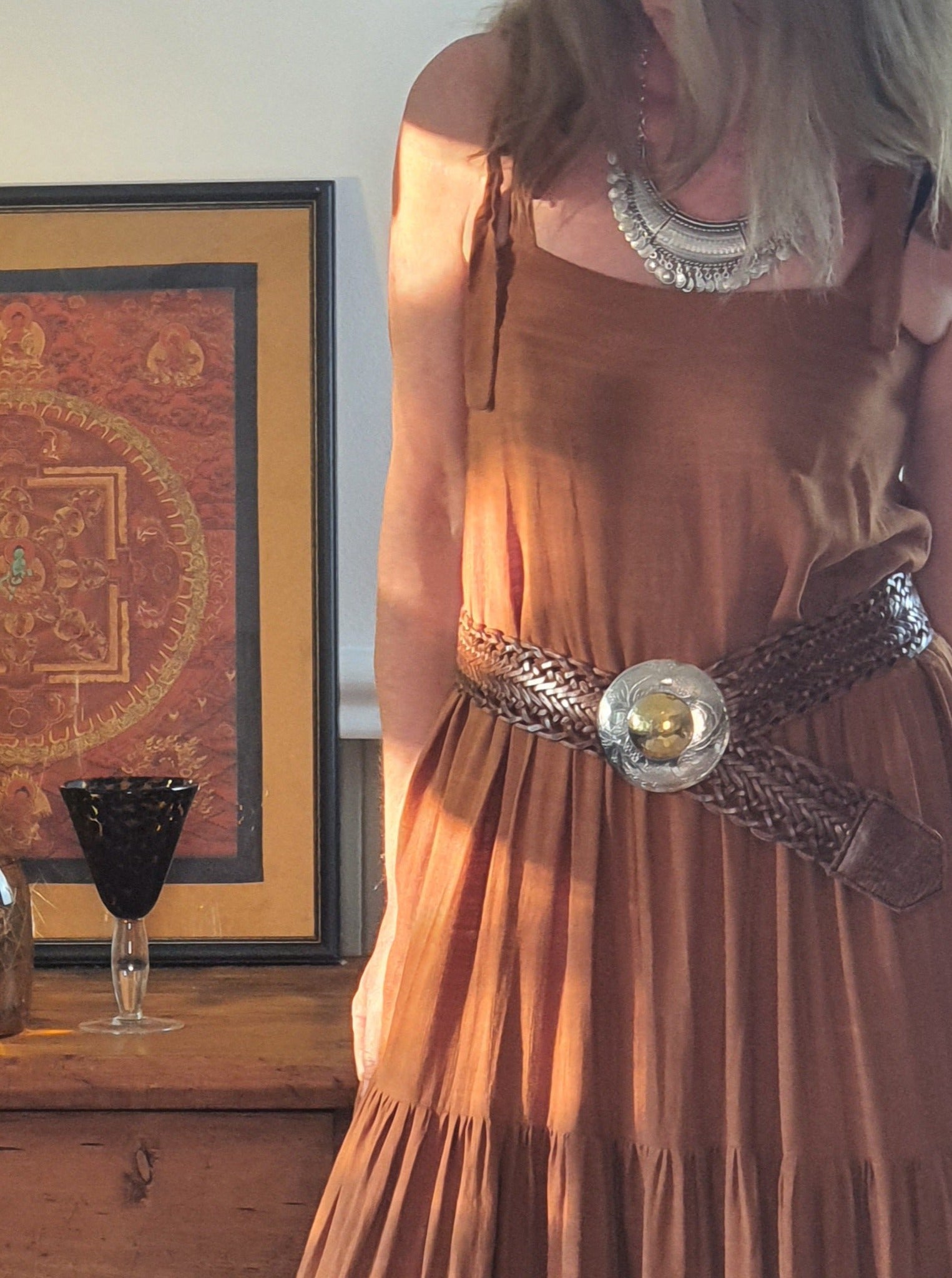 Woman wearing linen dress with leather moroccan belt with silver and gold buckle and turkish necklace